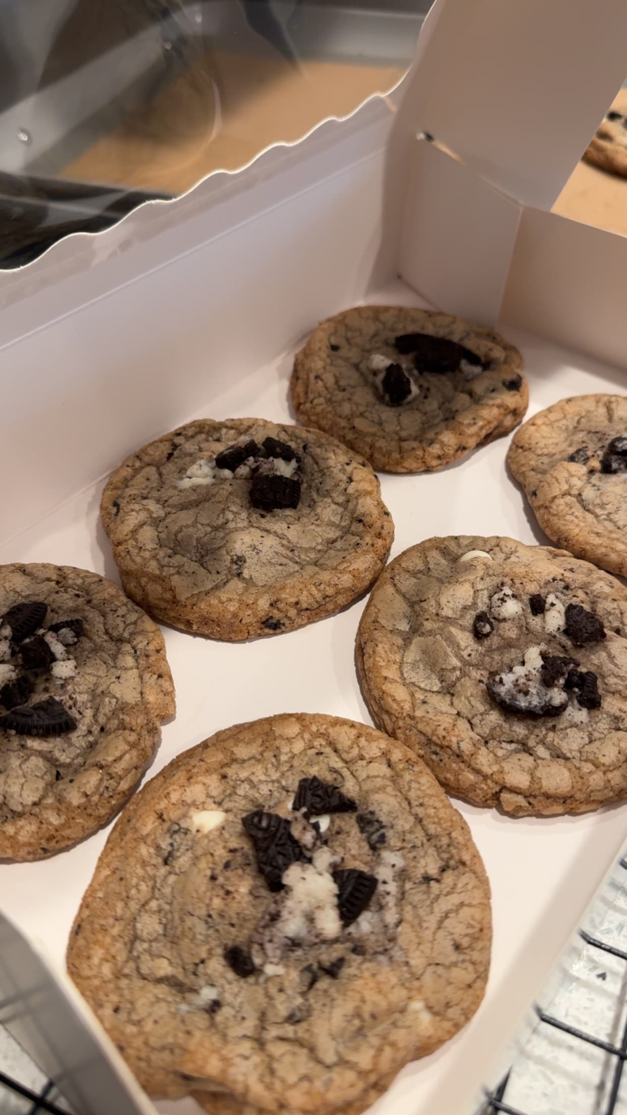 Chocolate chip cookies with Oreo pieces and white chocolate chunks, in a bakery box.