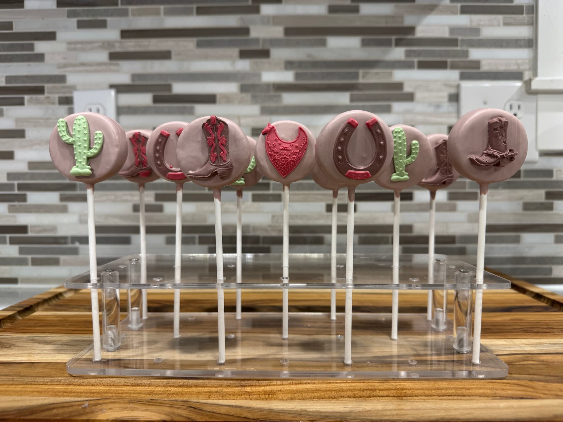 Western-themed cake pops with a cowboy hat and boot design.