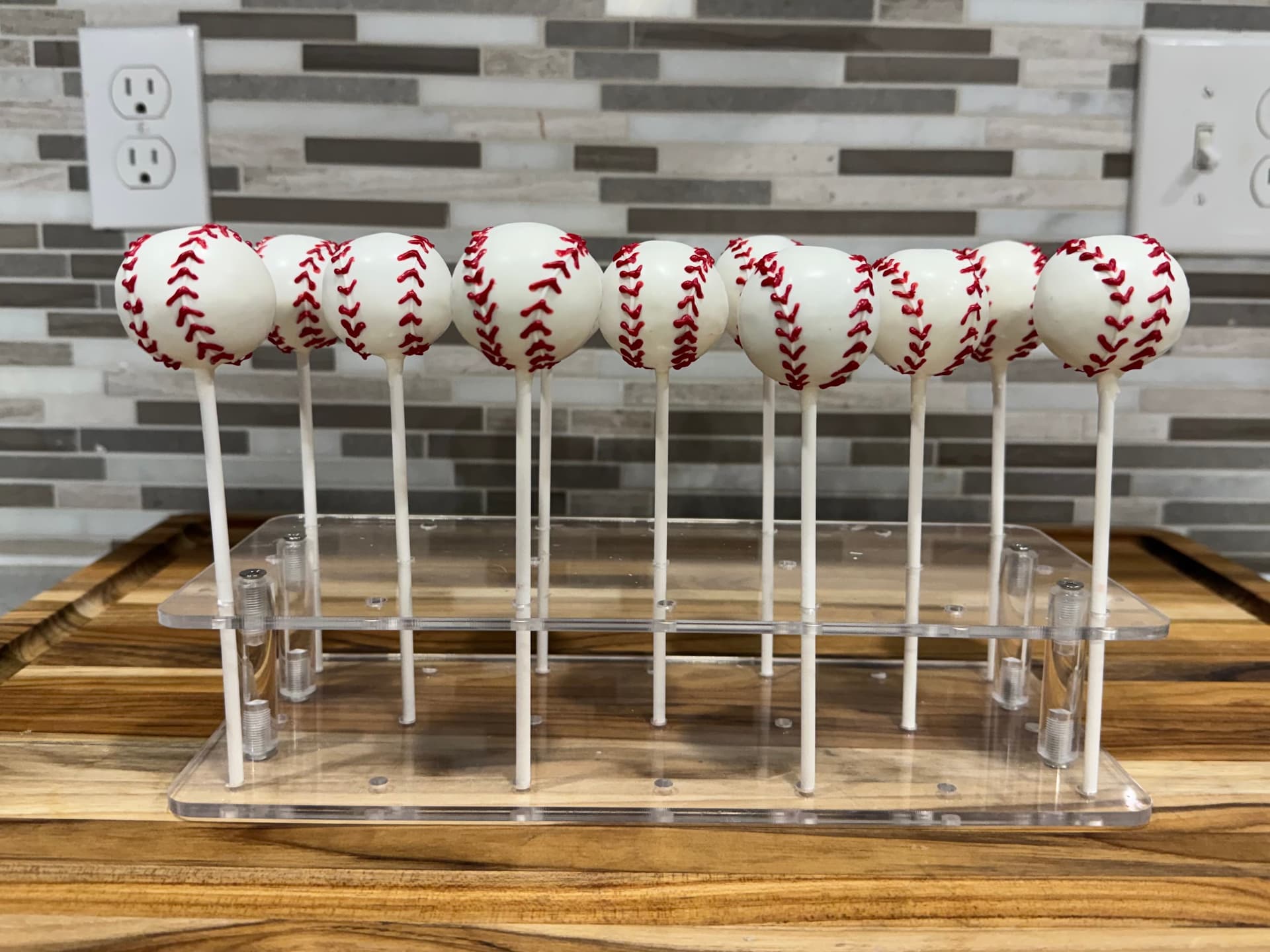 Cake pops decorated with a baseball design.