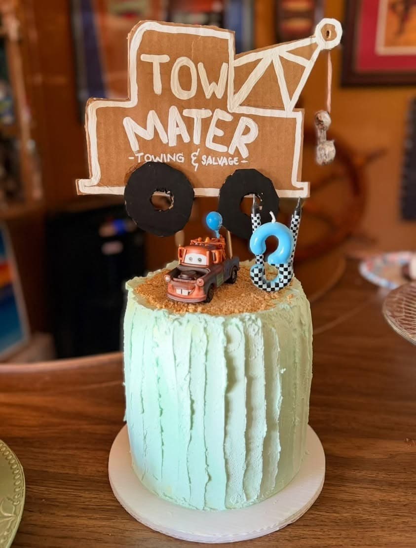 A cake decorated to look like Tow Mater from the movie Cars.