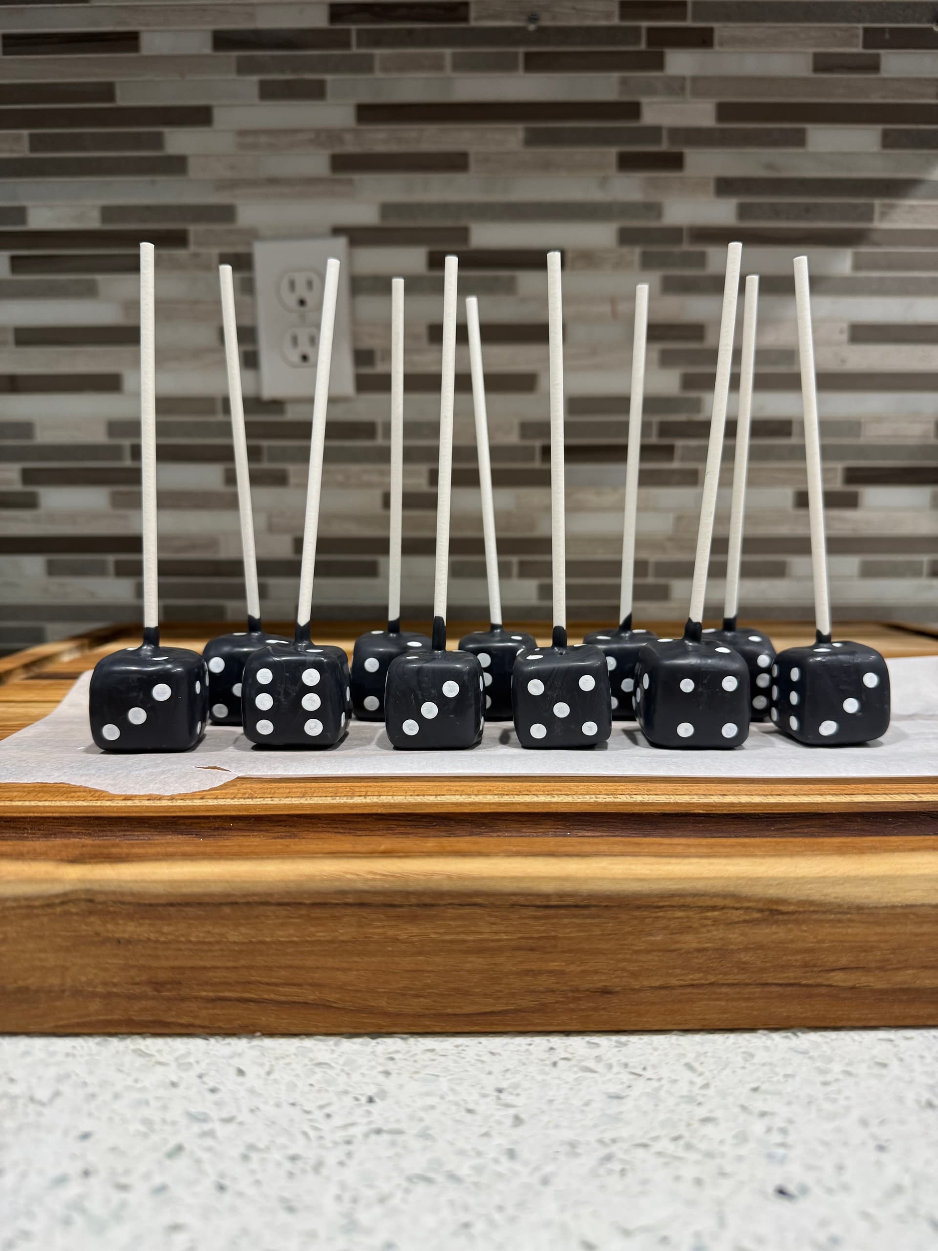 Dice-themed cake pops in black.