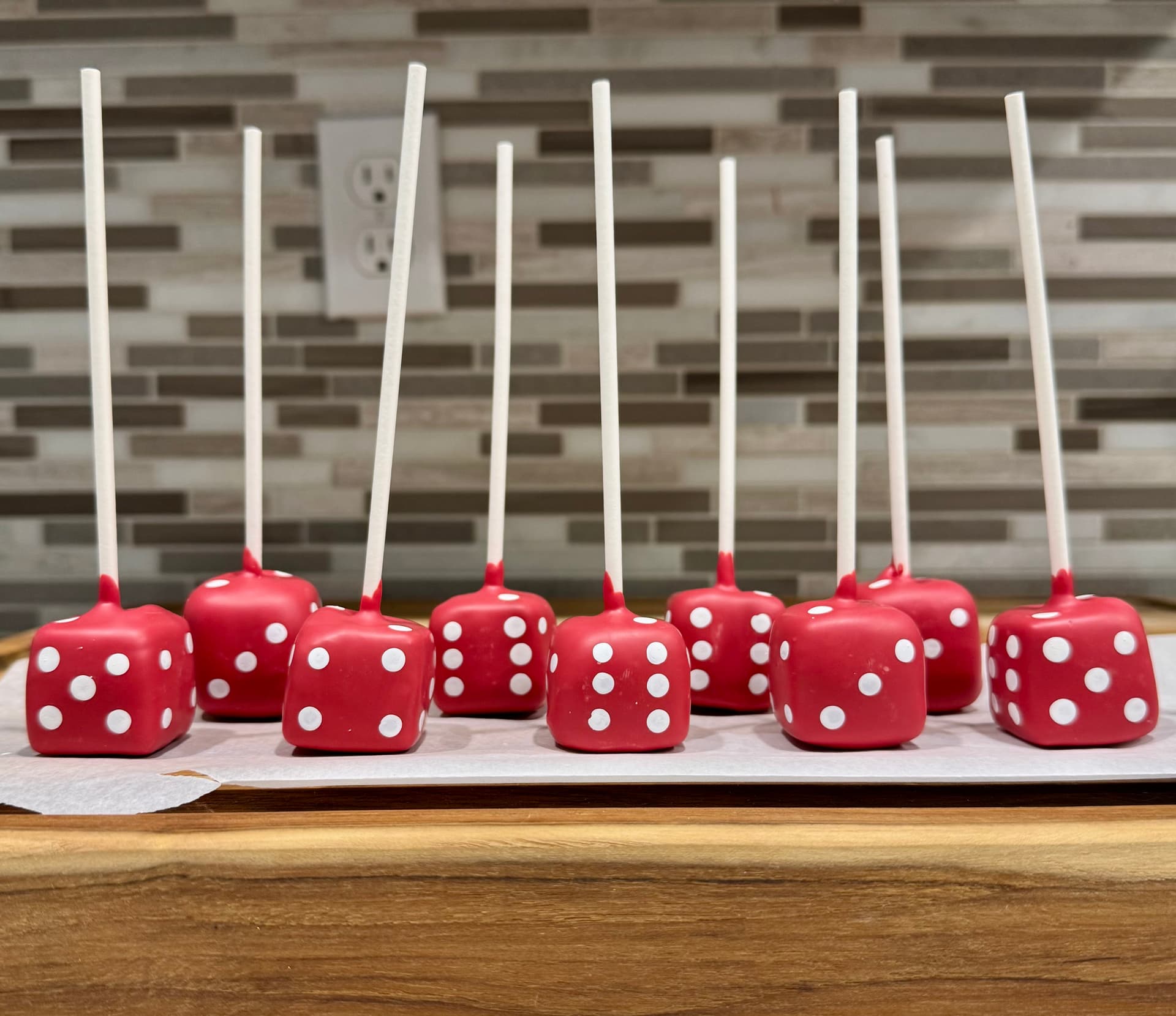 Dice-themed cake pops in red.
